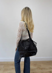 large black tote bag with long shoulder strap detail view