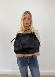 large black tote bag with long shoulder strap detail view