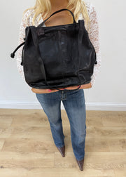 large black tote bag with long shoulder strap detail view