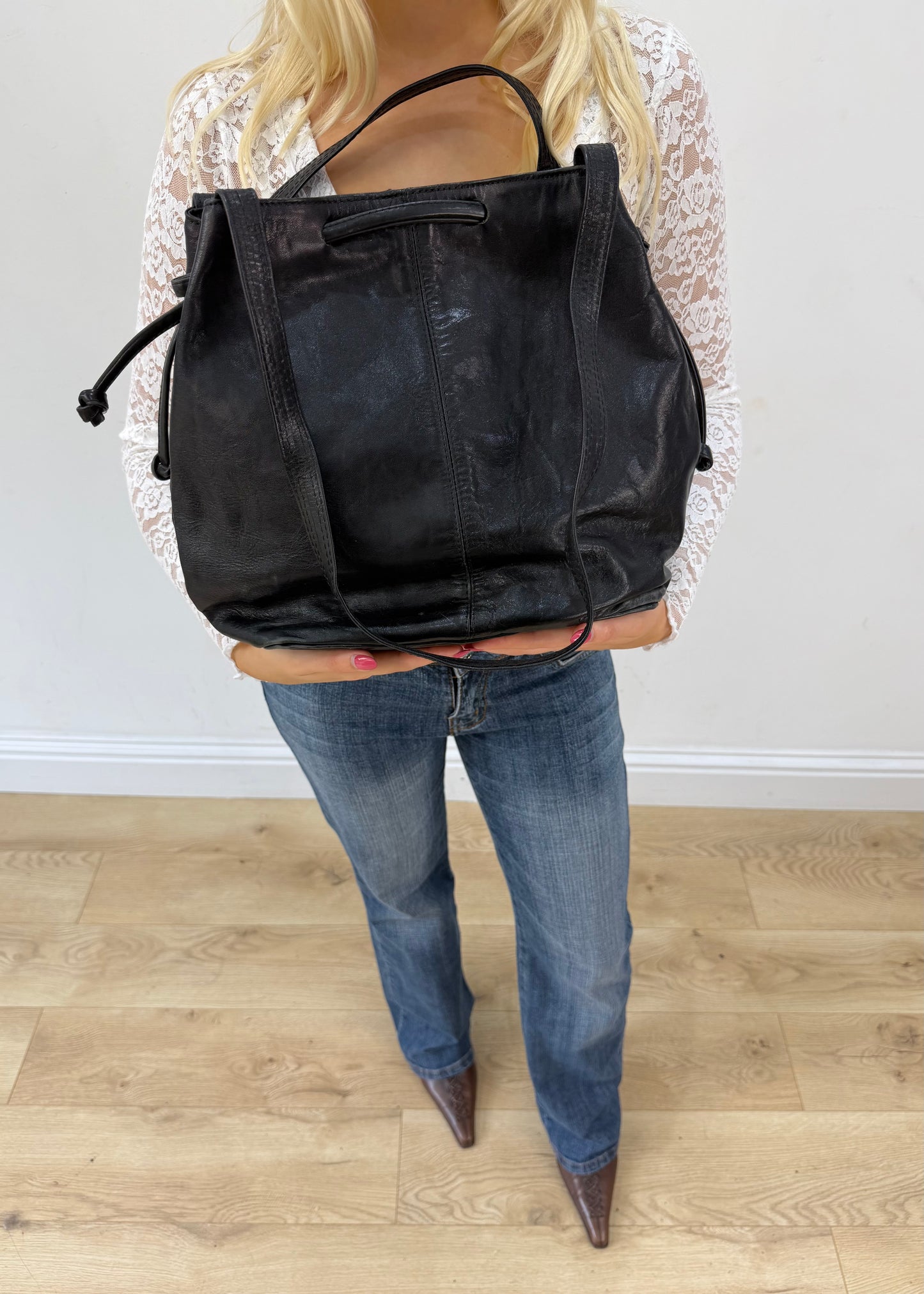 large black tote bag with long shoulder strap detail view