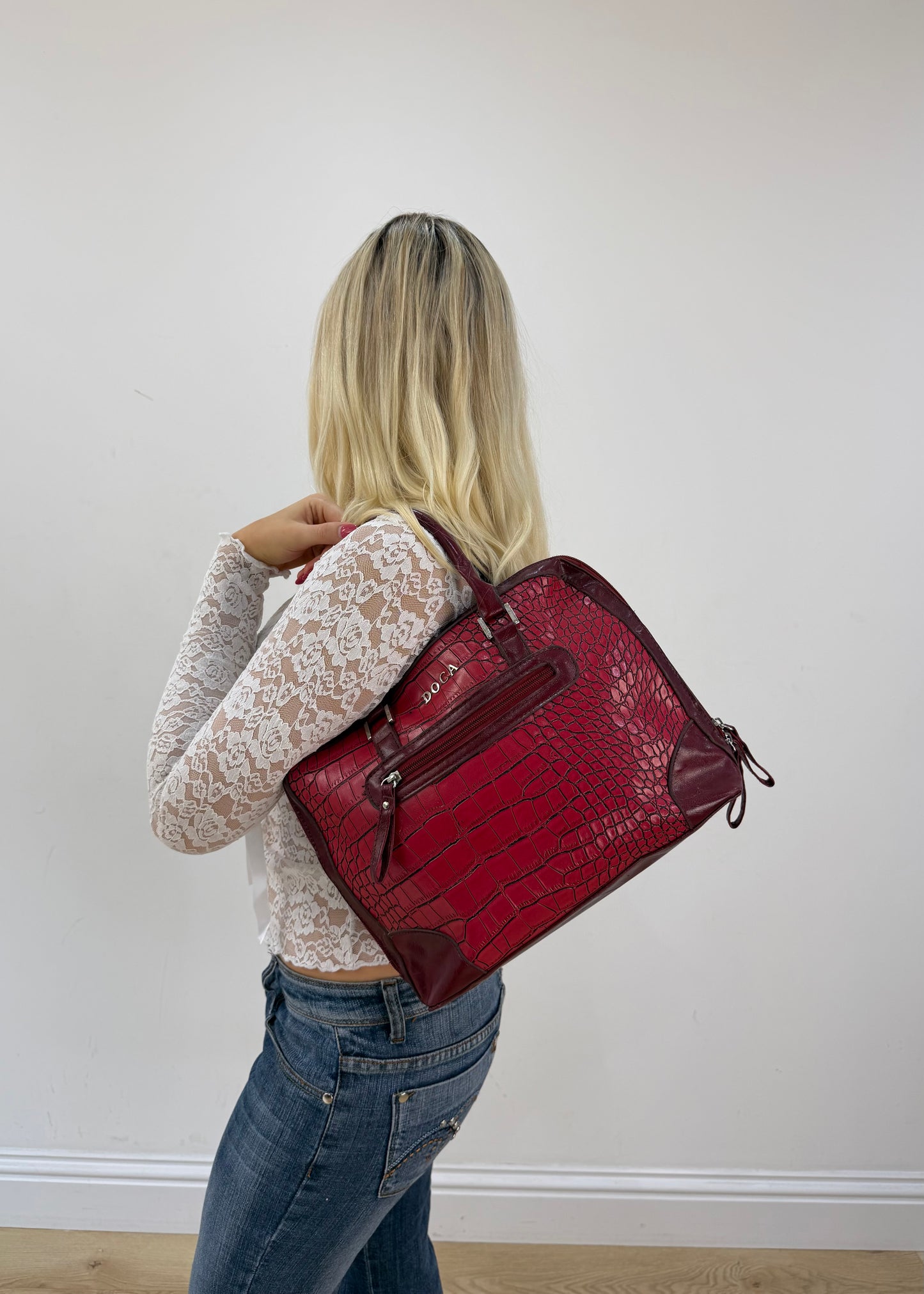 red structured satchel bag detail view
