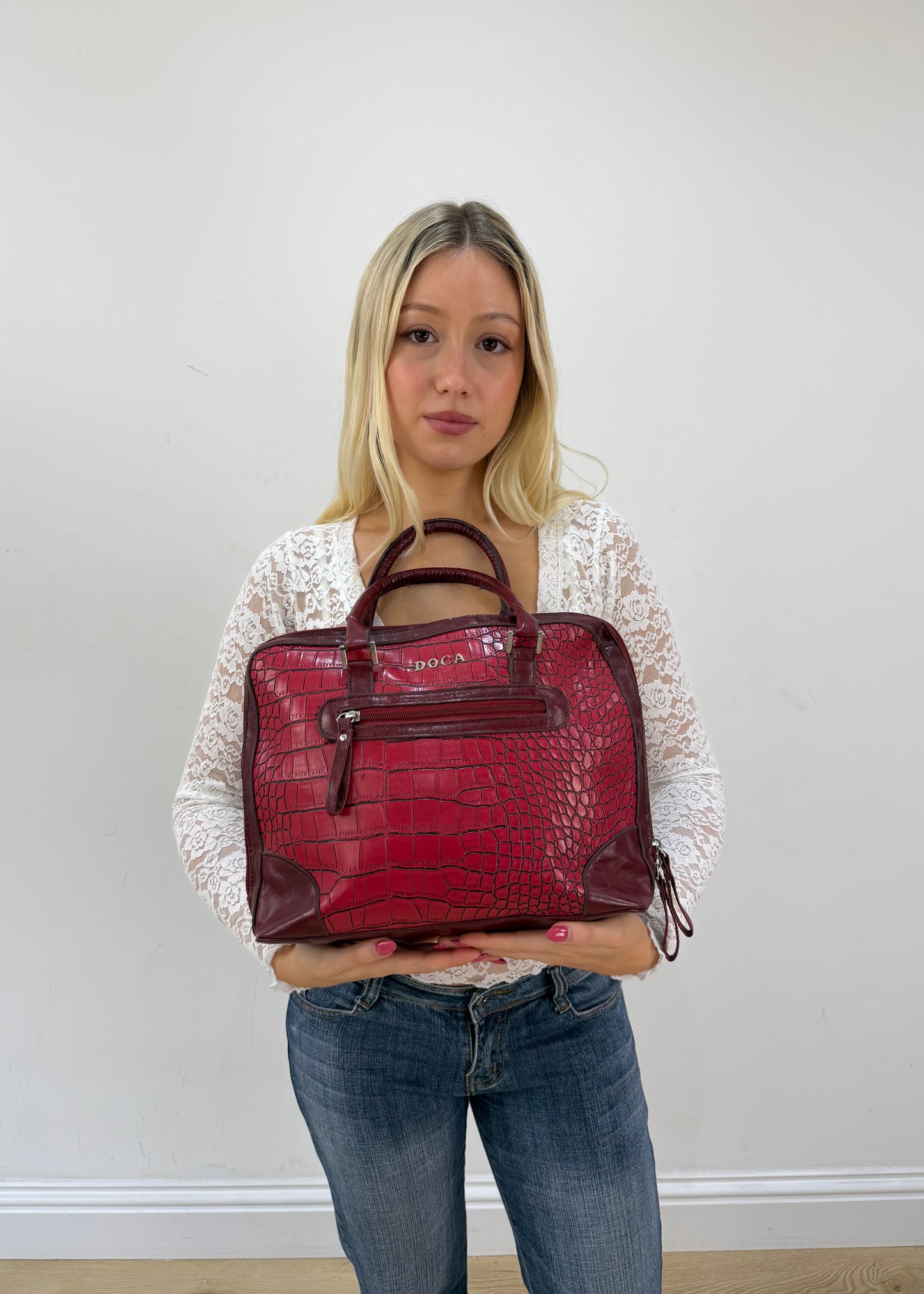red structured satchel bag detail view