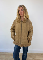 large camel quilted coat - face close-up