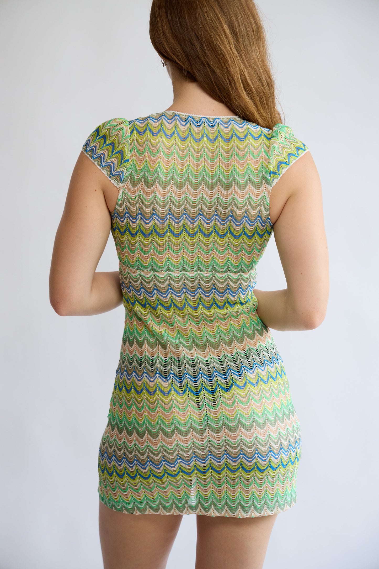 Model wearing the Allegra Dress in Pistachio Green – back view