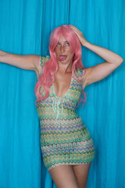 Allegra Dress in Pistachio Green – campaign pose on blue backdrop