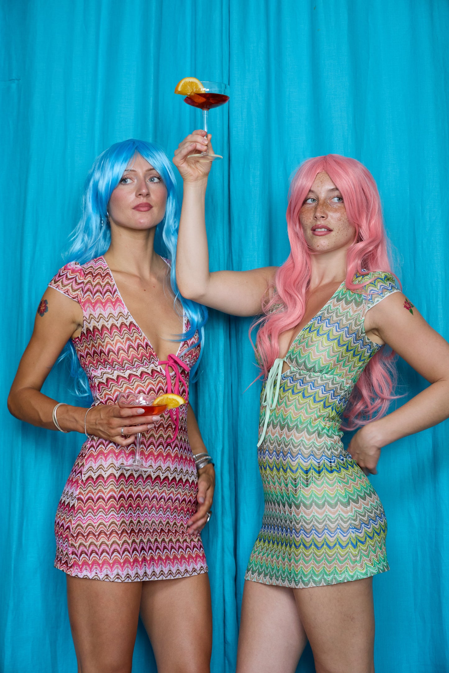 Models wearing Allegra Dresses in Candyfloss Pink and Pistachio Green