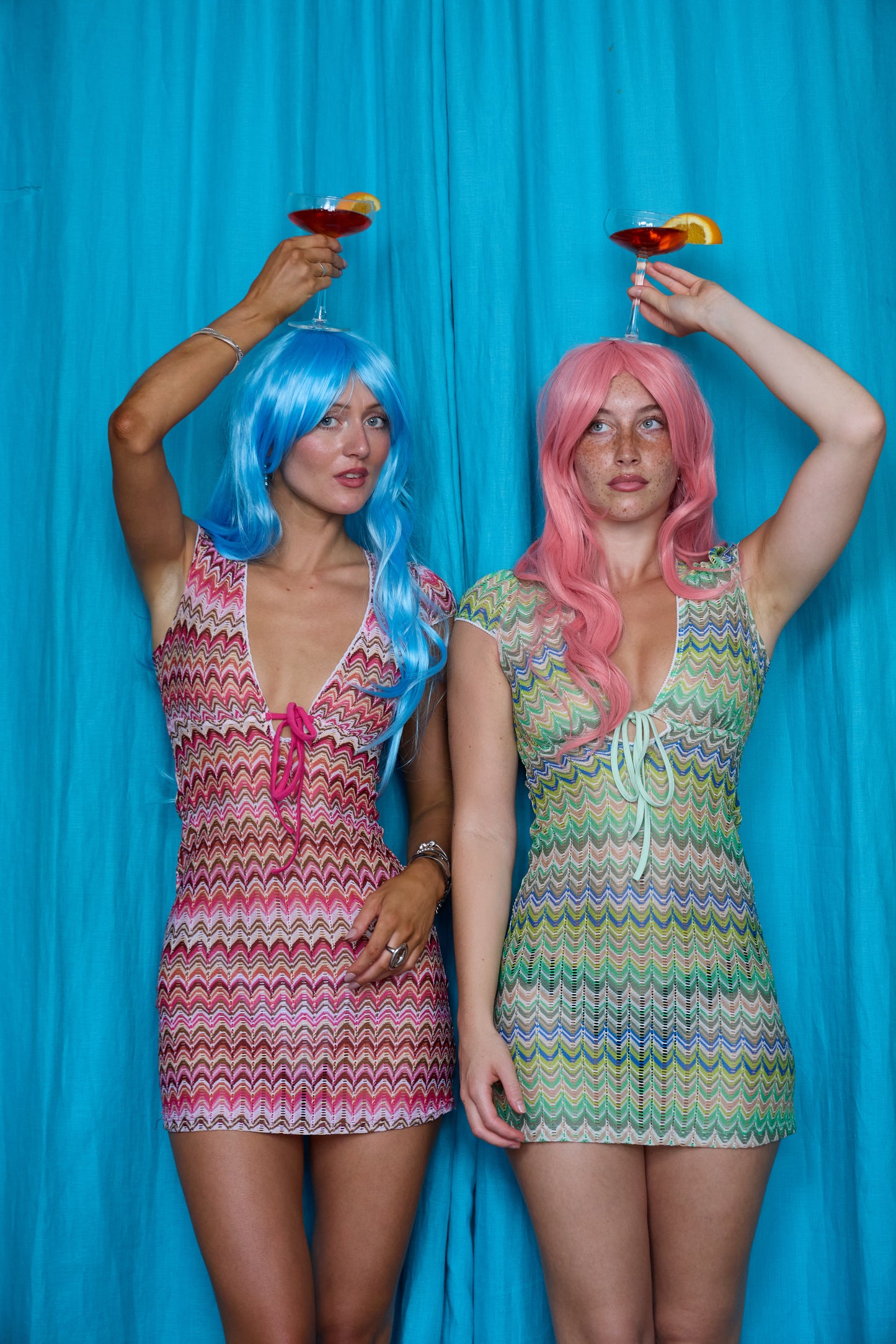 Models wearing Allegra Dresses in Candyfloss Pink and Pistachio Green