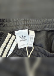 small black adidas tracksuit bottoms label