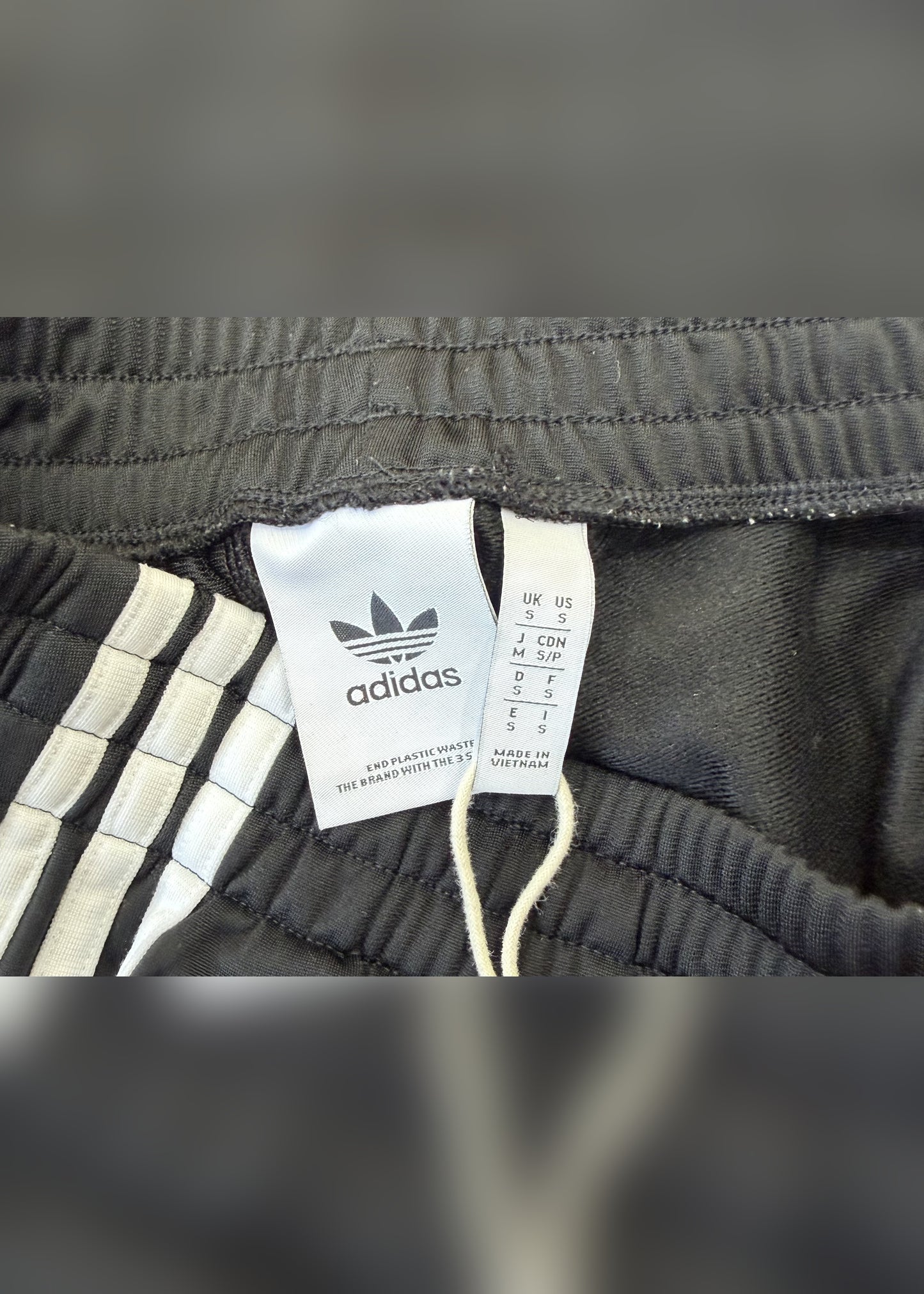 small black adidas tracksuit bottoms label