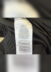 small black adidas tracksuit bottoms label