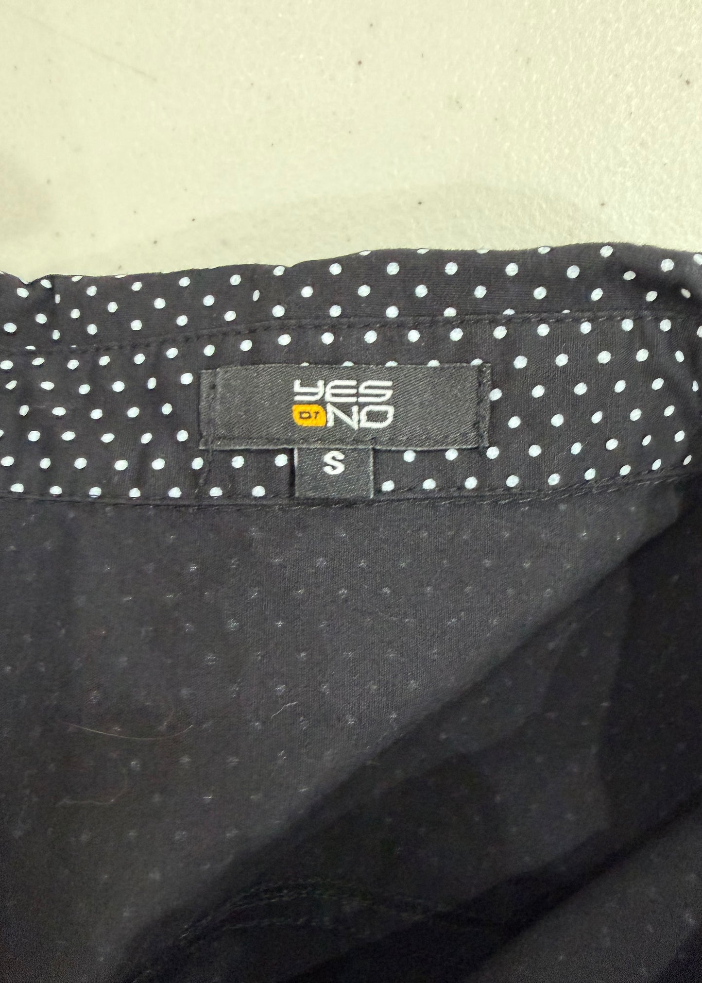 small black plaid top with pink ribbon detail care label