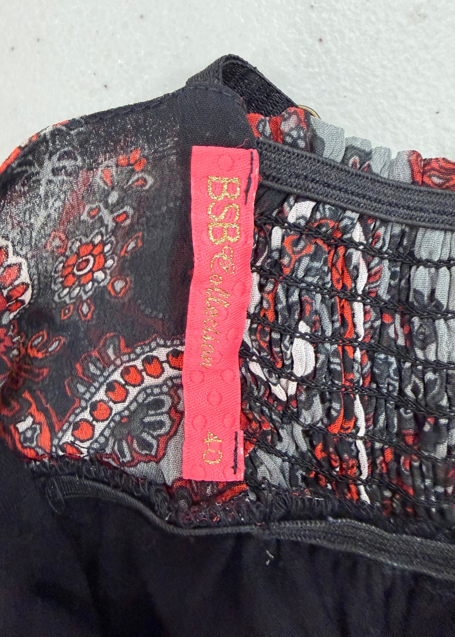 small red and black patterned mini dress size label