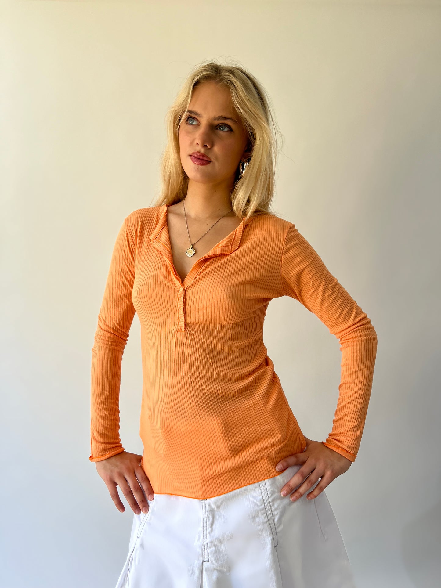 large orange ribbed button long sleeve top close front view