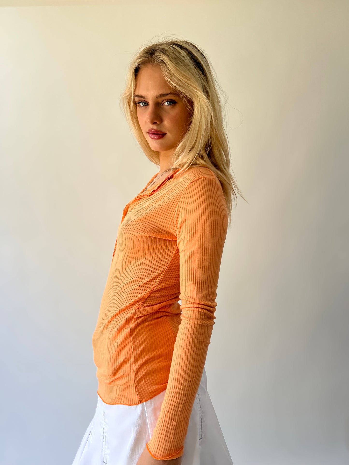 large orange ribbed button long sleeve top side view