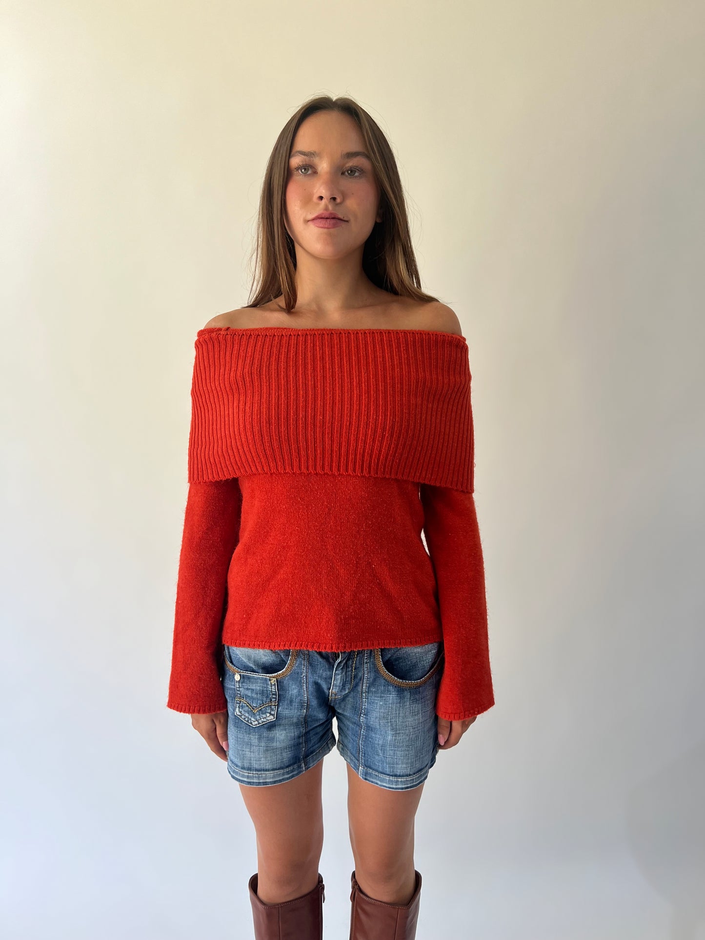 large orange off-shoulder ribbed sweater angled view