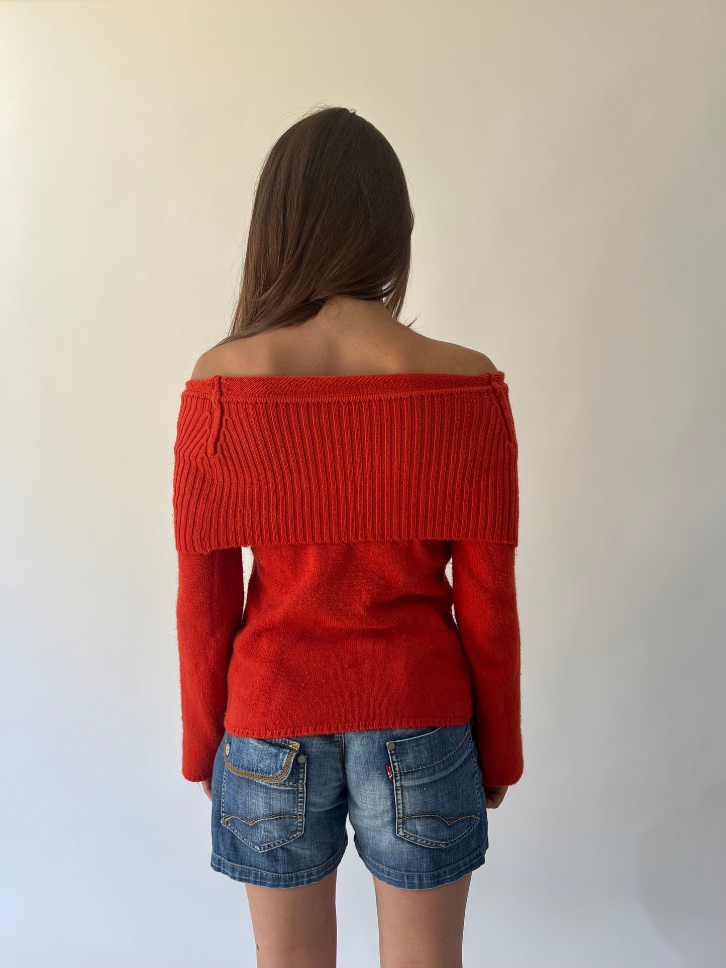 large orange off-shoulder ribbed sweater back view