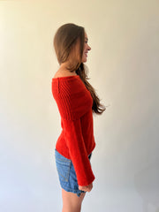 large orange off-shoulder ribbed sweater detail