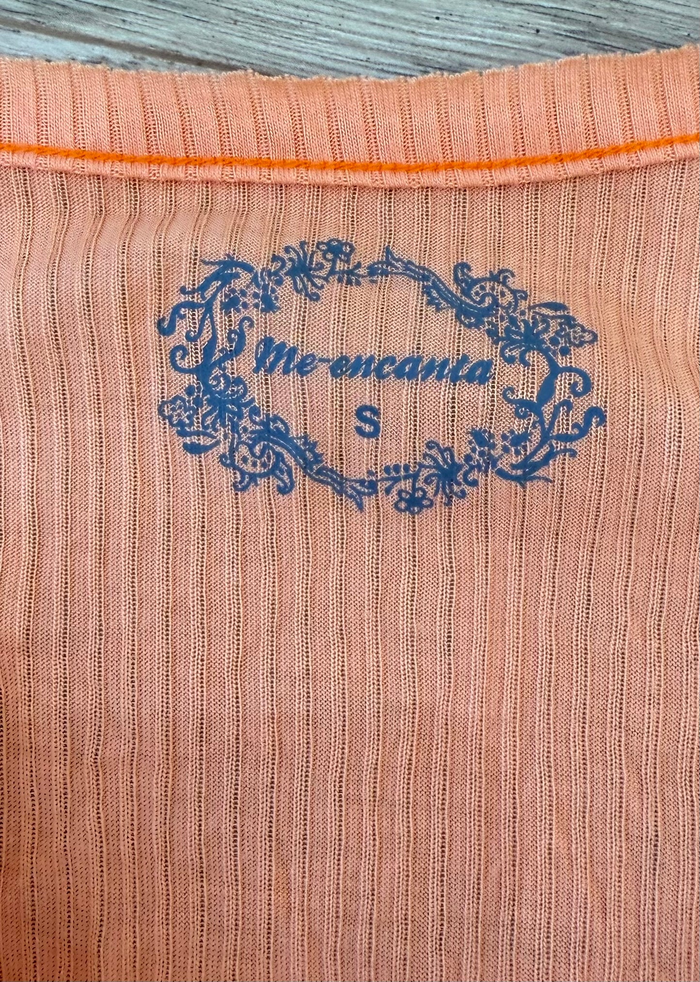 medium orange ribbed button long sleeve top care label