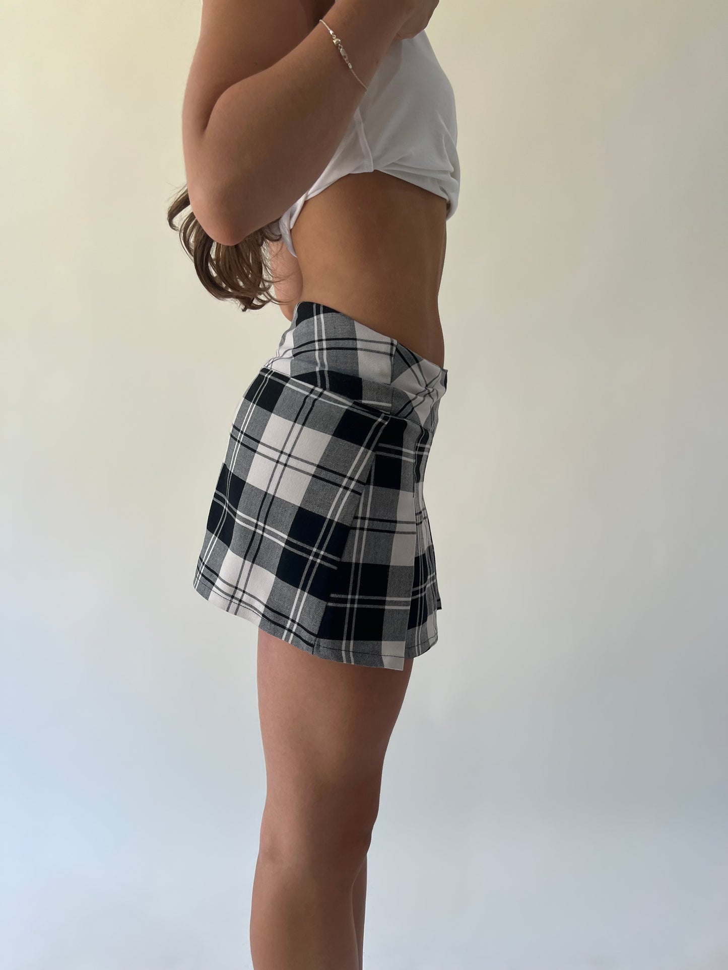 small black and white plaid pleated mini skirt side view