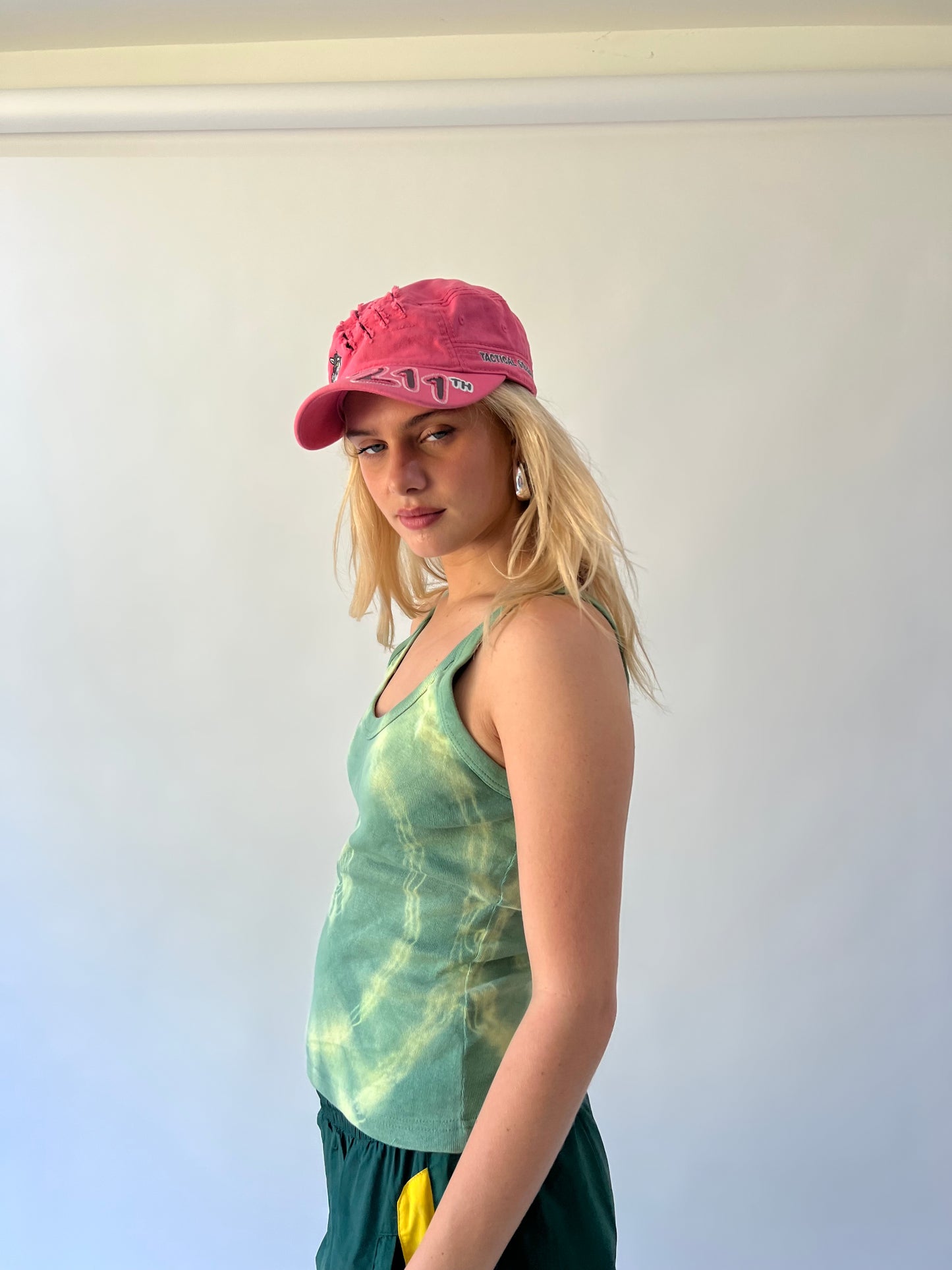small pink 211 embroidered cap worn side view