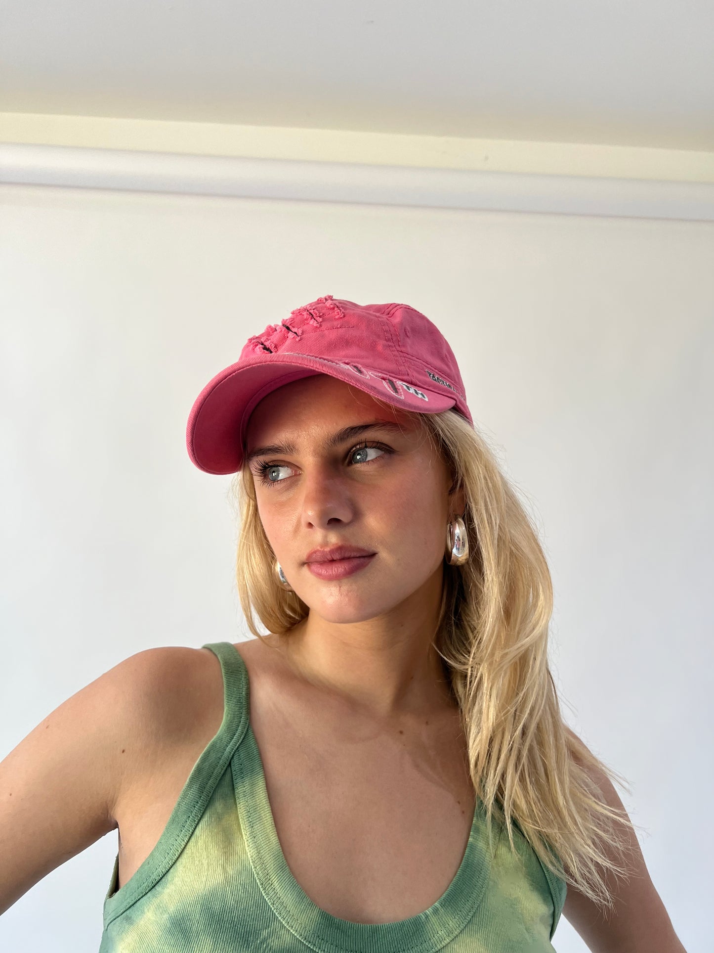 small pink 211 embroidered cap close worn view