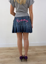 medium denim pleated mini skirt with pink spellout on the back