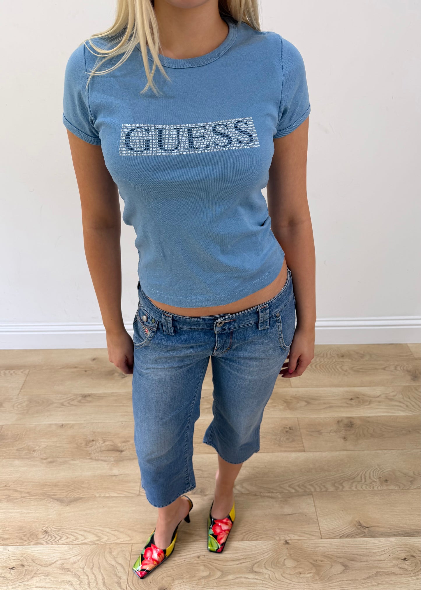 small blue guess t-shirt posed