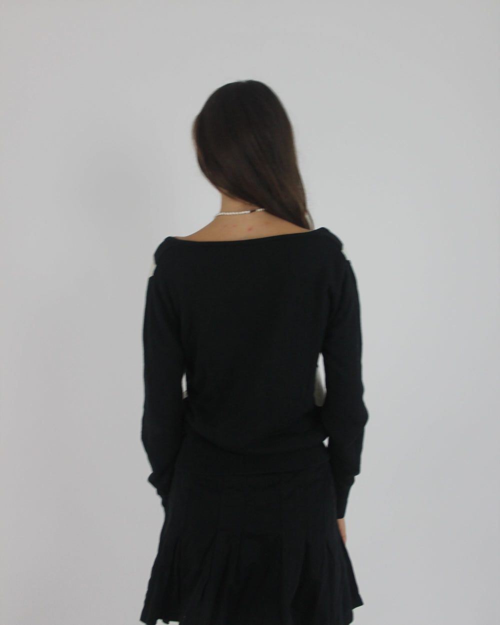 black and white argyle v-neck jumper back view