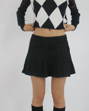 black pleated mini skirt front view