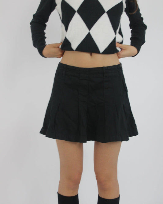black pleated mini skirt front view