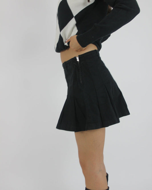 black pleated mini skirt back view