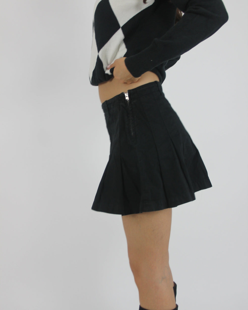 black pleated mini skirt back view