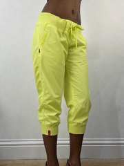 Neon green cropped joggers, steamed, angled view