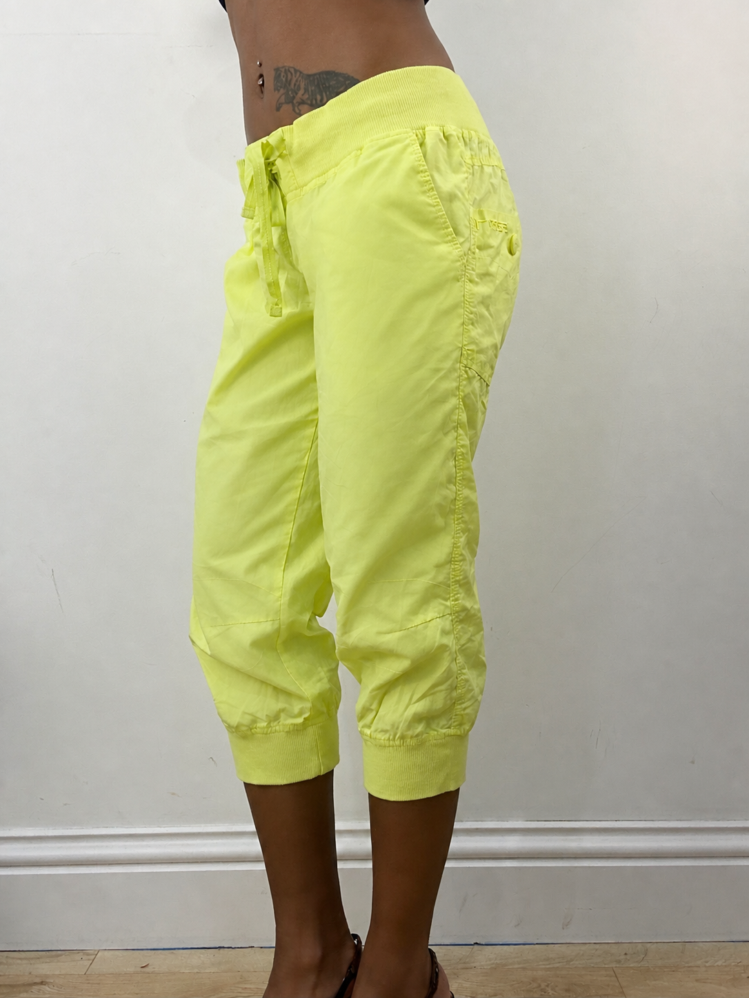 Neon green cropped joggers, steamed, side view