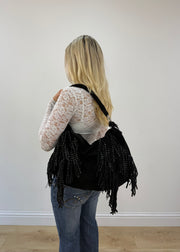 black E&L Eternel studded fringe shoulder bag worn on shoulder