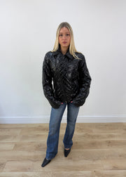 medium black glossy quilted jacket with embroidered back crest image 1