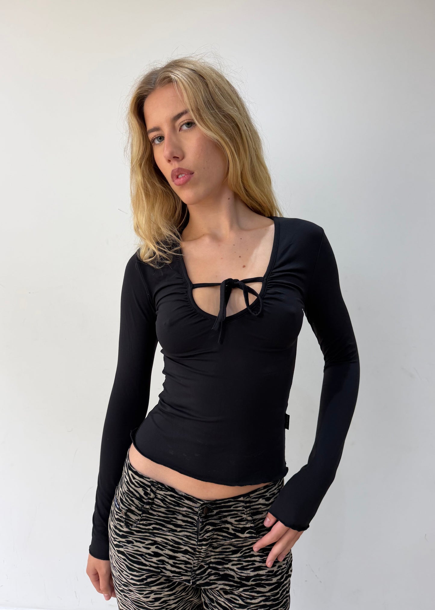 small black cutout-neckline long-sleeve top — photographed on Lily
