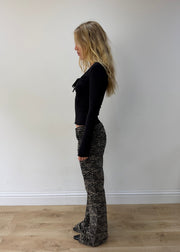 small black and cream zebra-print flared trousers — photographed on Lily