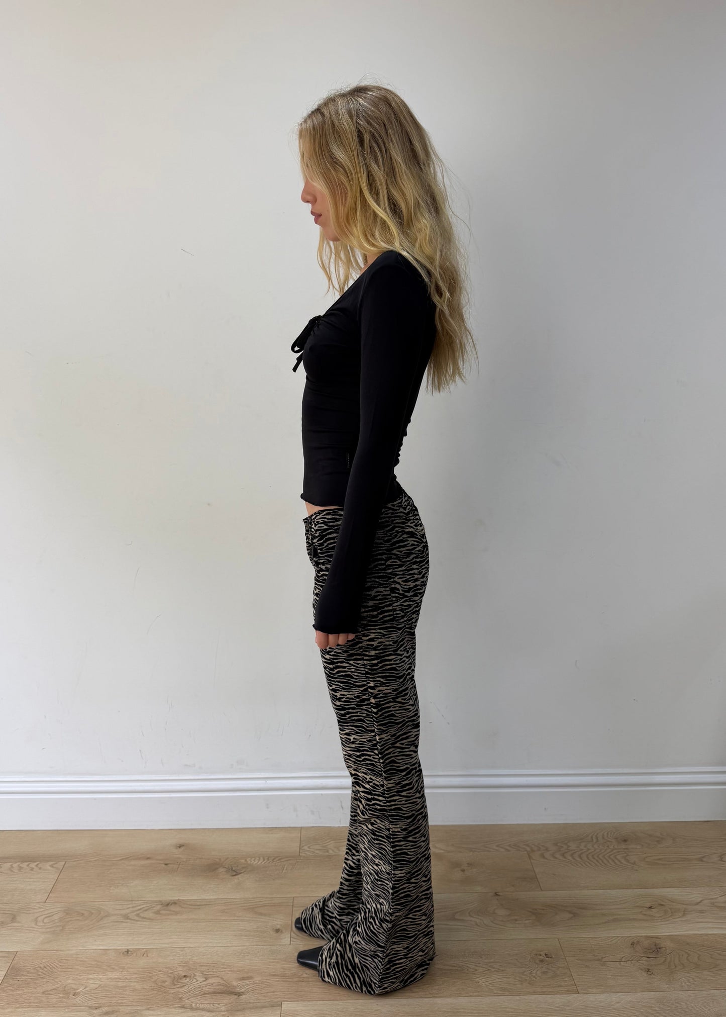 small black and cream zebra-print flared trousers — photographed on Lily