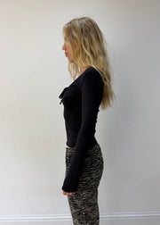 small black cutout-neckline long-sleeve top — photographed on Lily