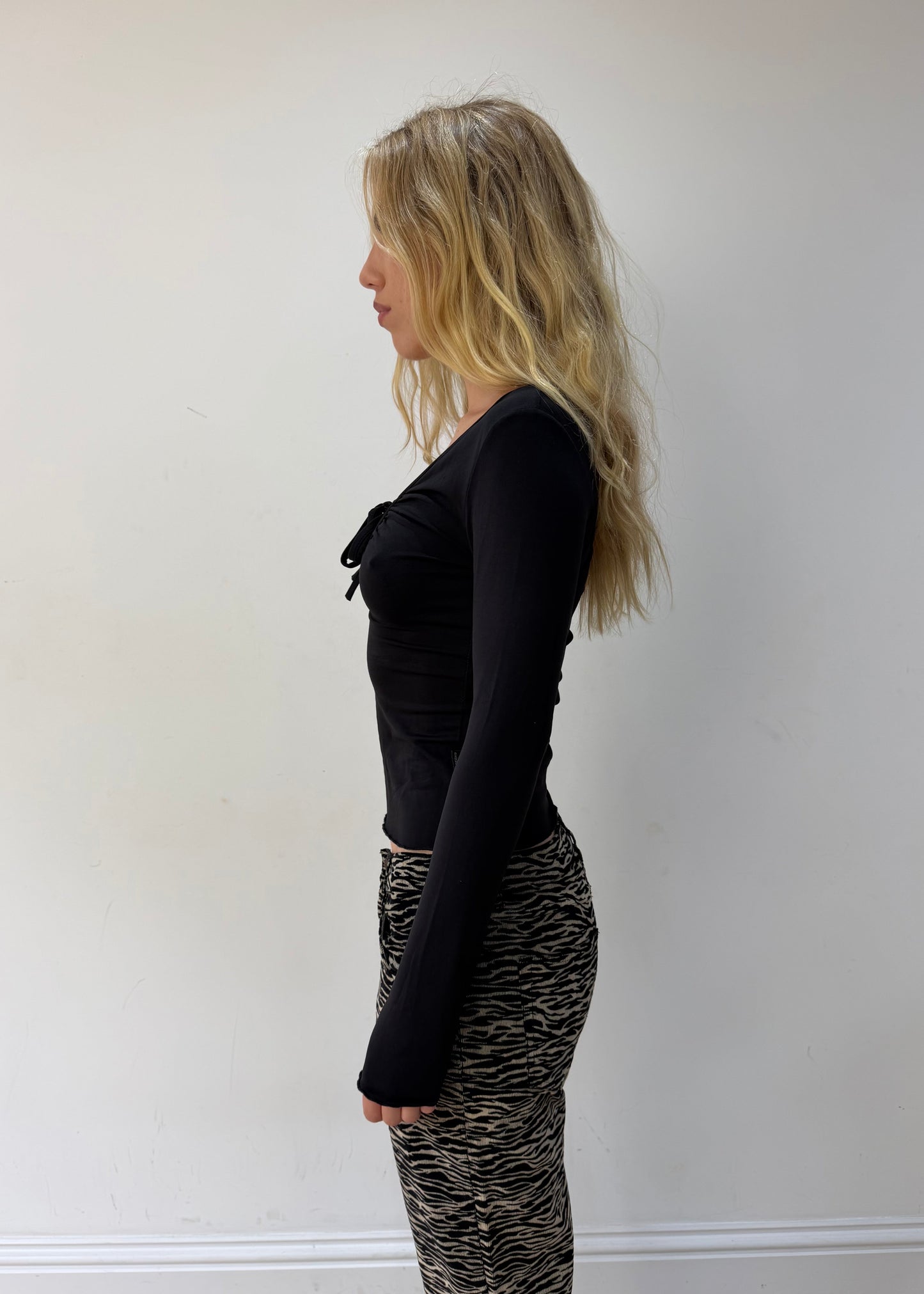 small black cutout-neckline long-sleeve top — photographed on Lily
