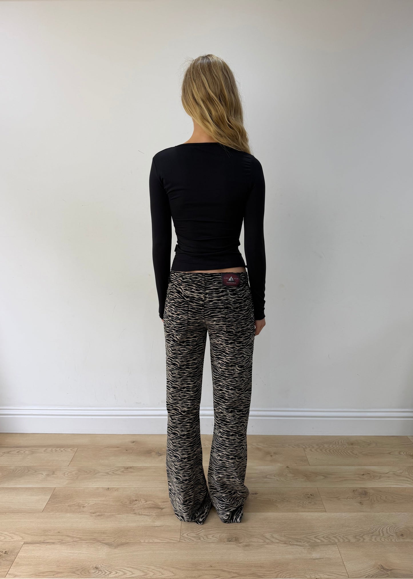 small black and cream zebra-print flared trousers — photographed on Lily