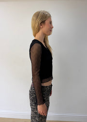 small black mesh ruffle-hem long-sleeve top — photographed on Lily