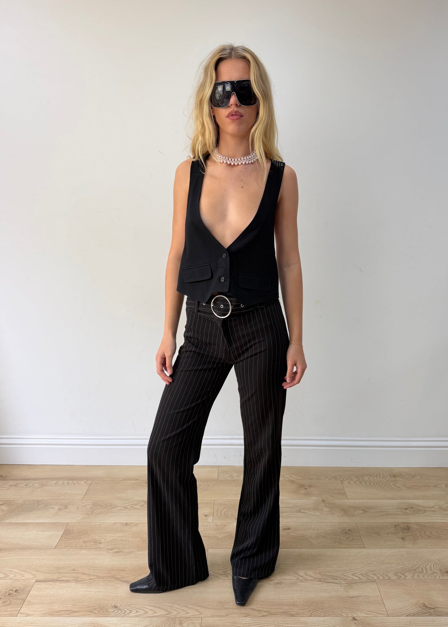 small black pinstripe buckle-belt flared trousers — photographed on Lily