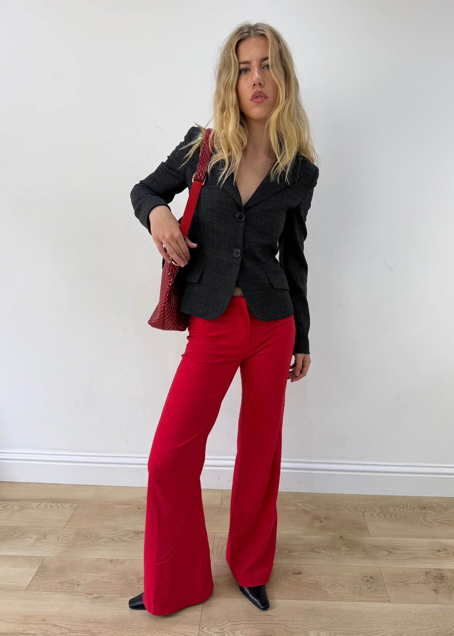small charcoal grey ruffle-hem fitted blazer — photographed on Lily
