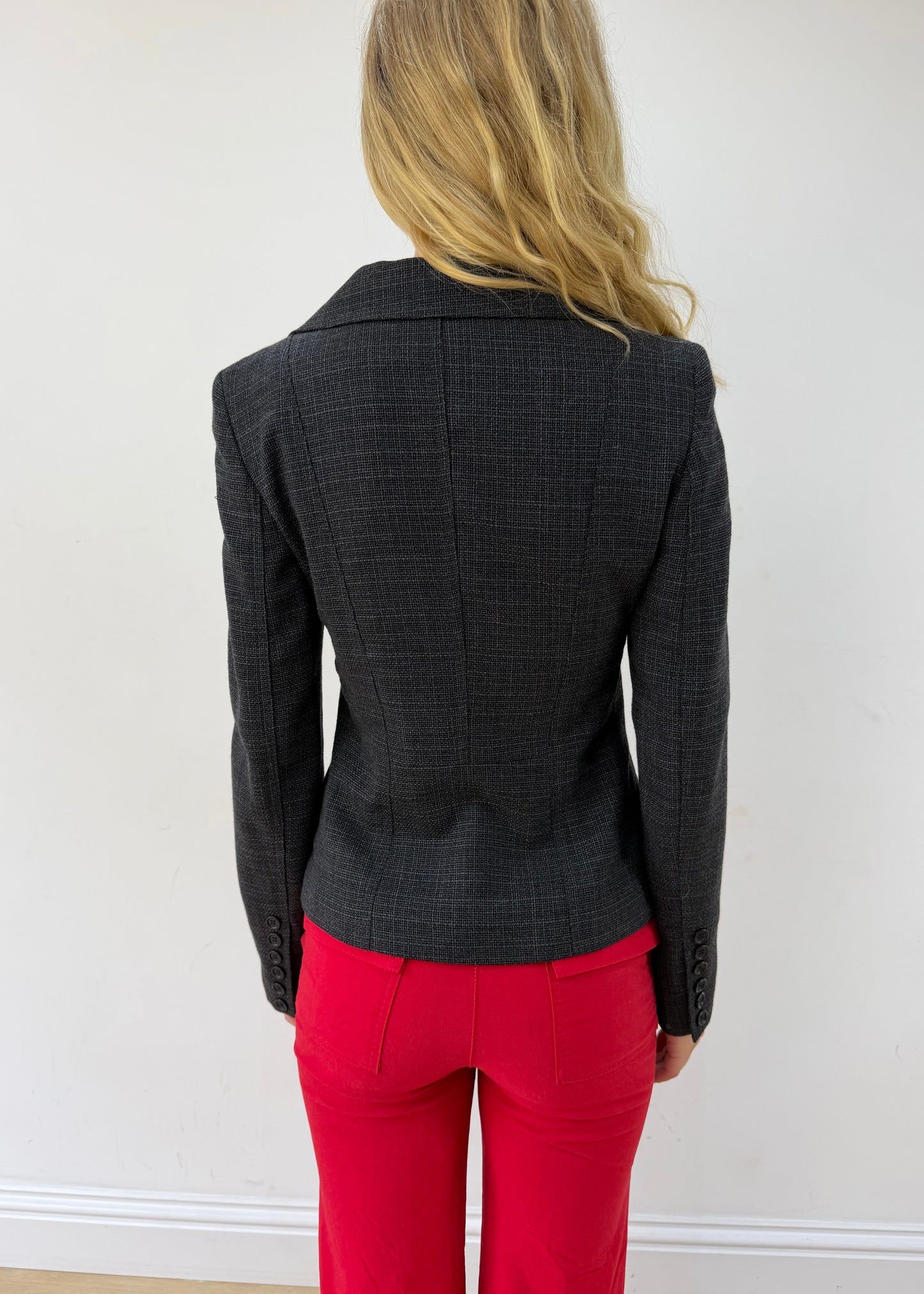 small charcoal grey ruffle-hem fitted blazer — photographed on Lily