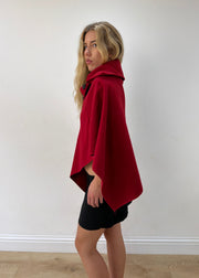 one size red button-detail asymmetric poncho — photographed on Lily
