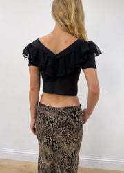 small black ruffle cropped short-sleeve top — photographed on Lily