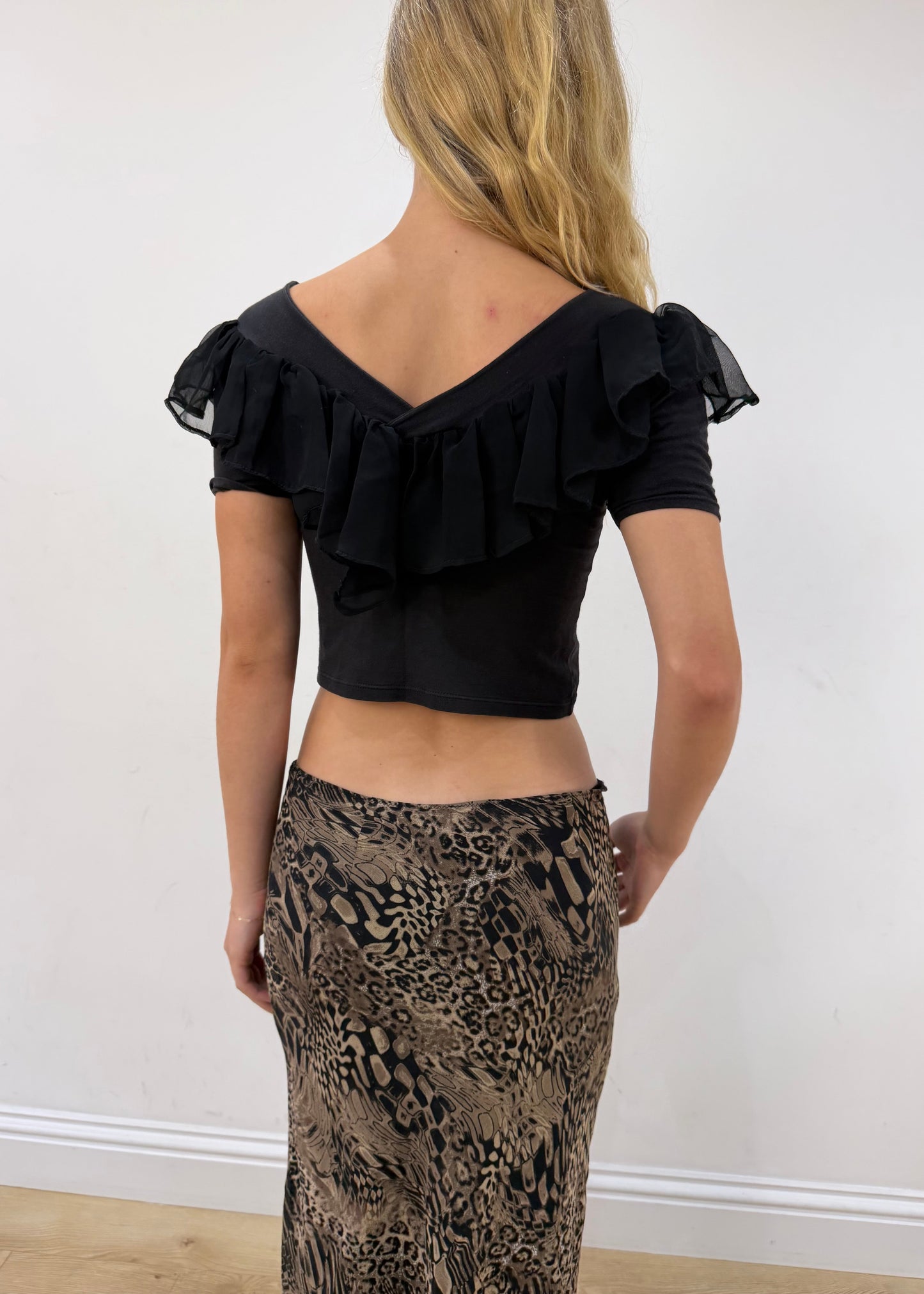small black ruffle cropped short-sleeve top — photographed on Lily