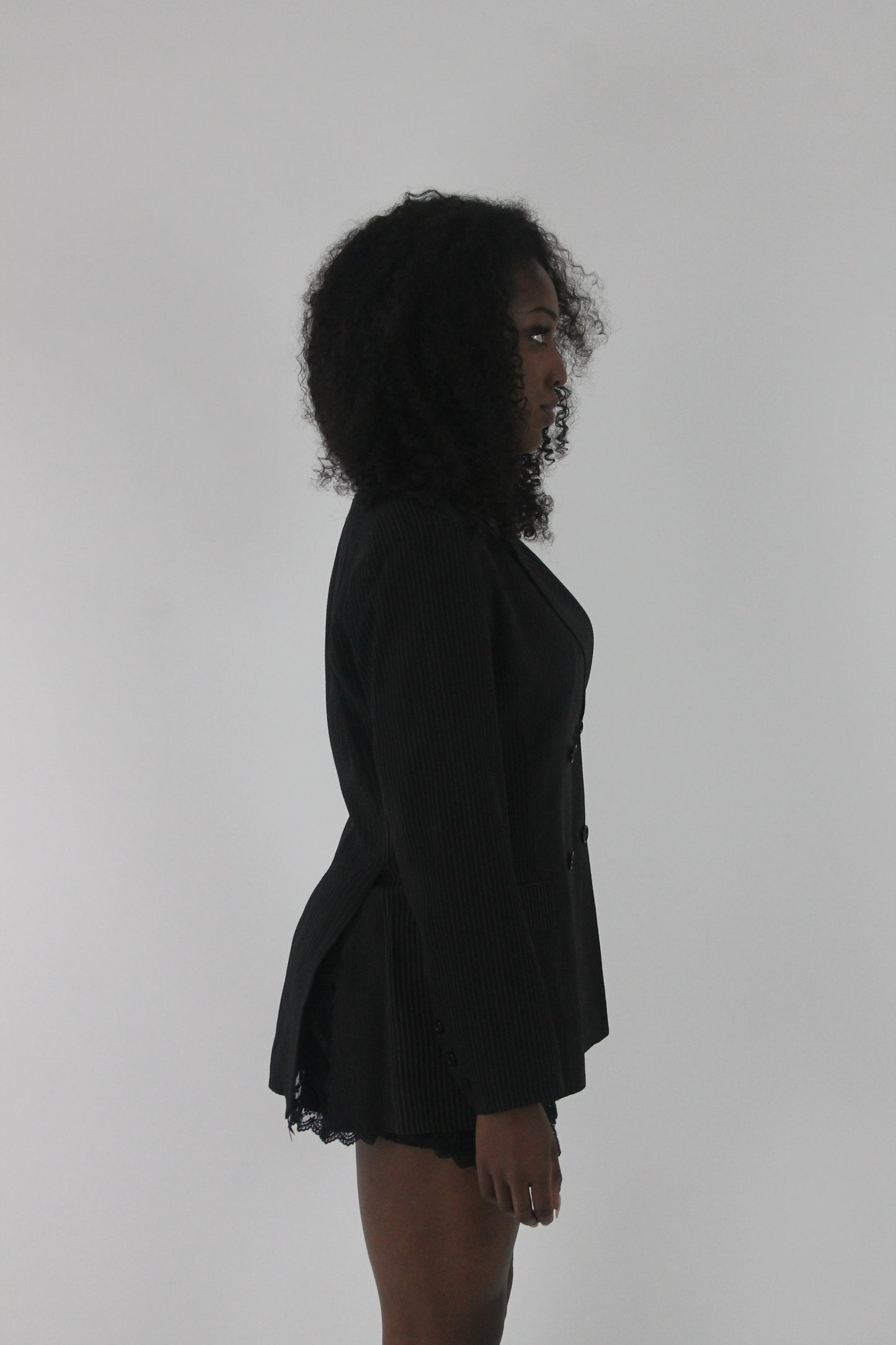 alternate-side view of black pinstripe single-button blazer